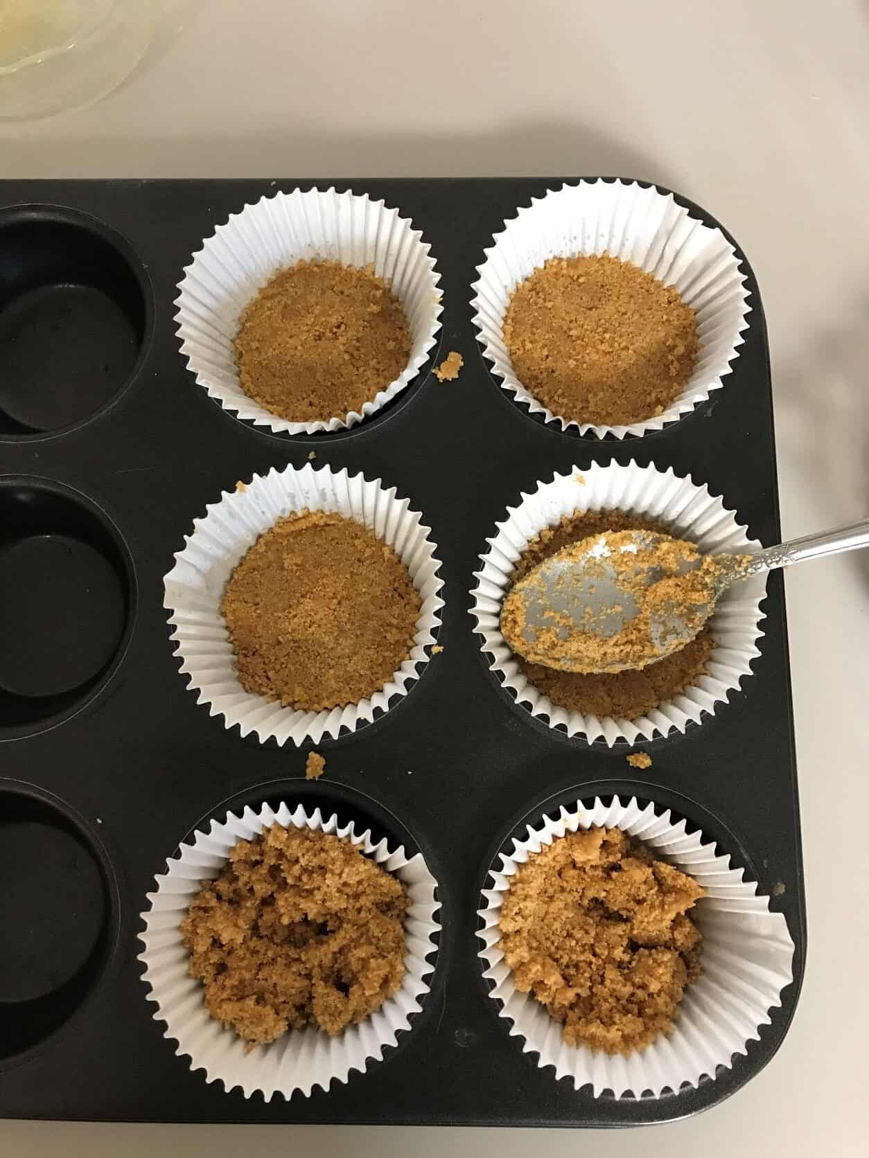 graham cracker crumbs in a muffin liner