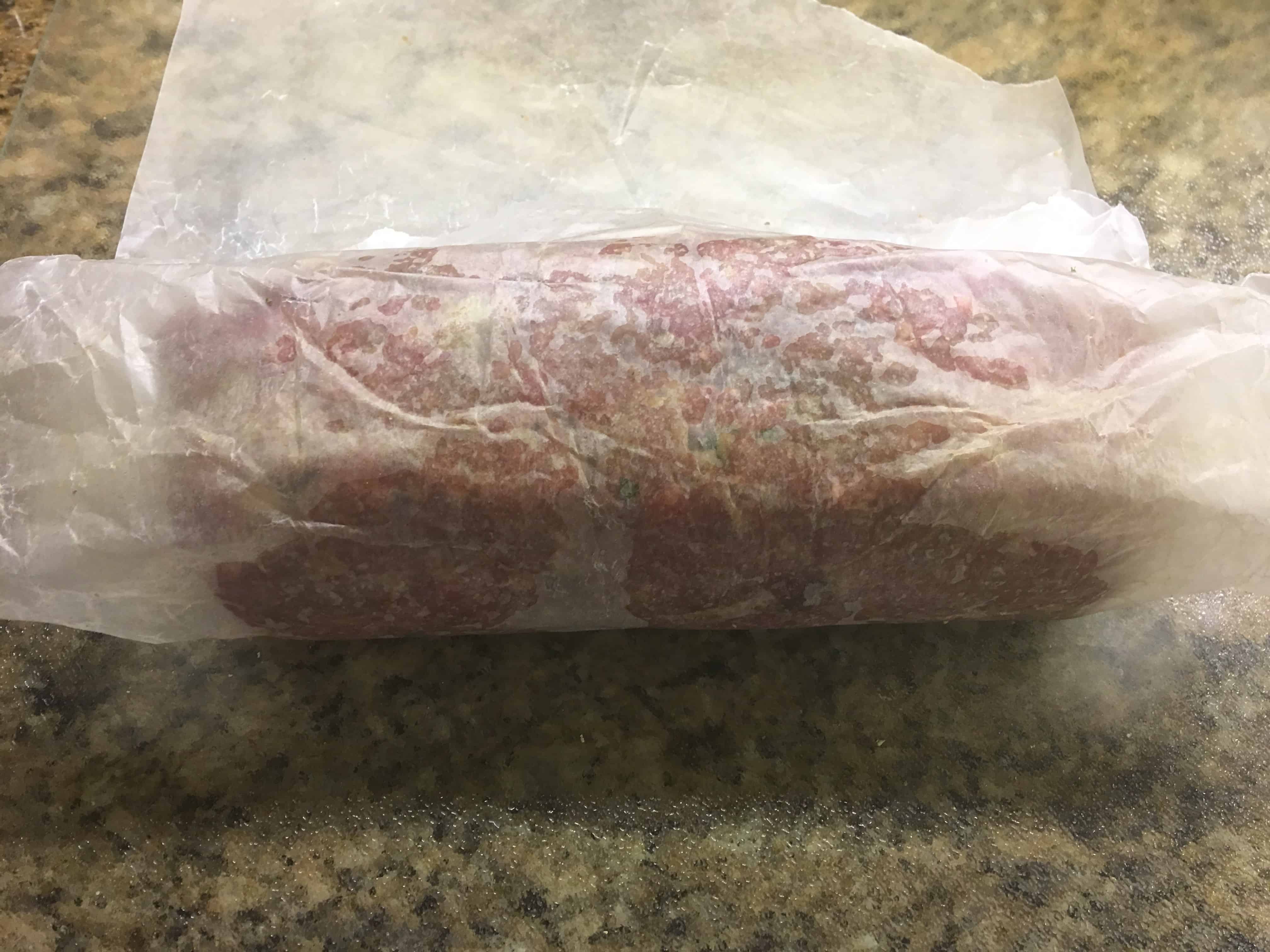 Meatloaf wrapped into shape by wax paper