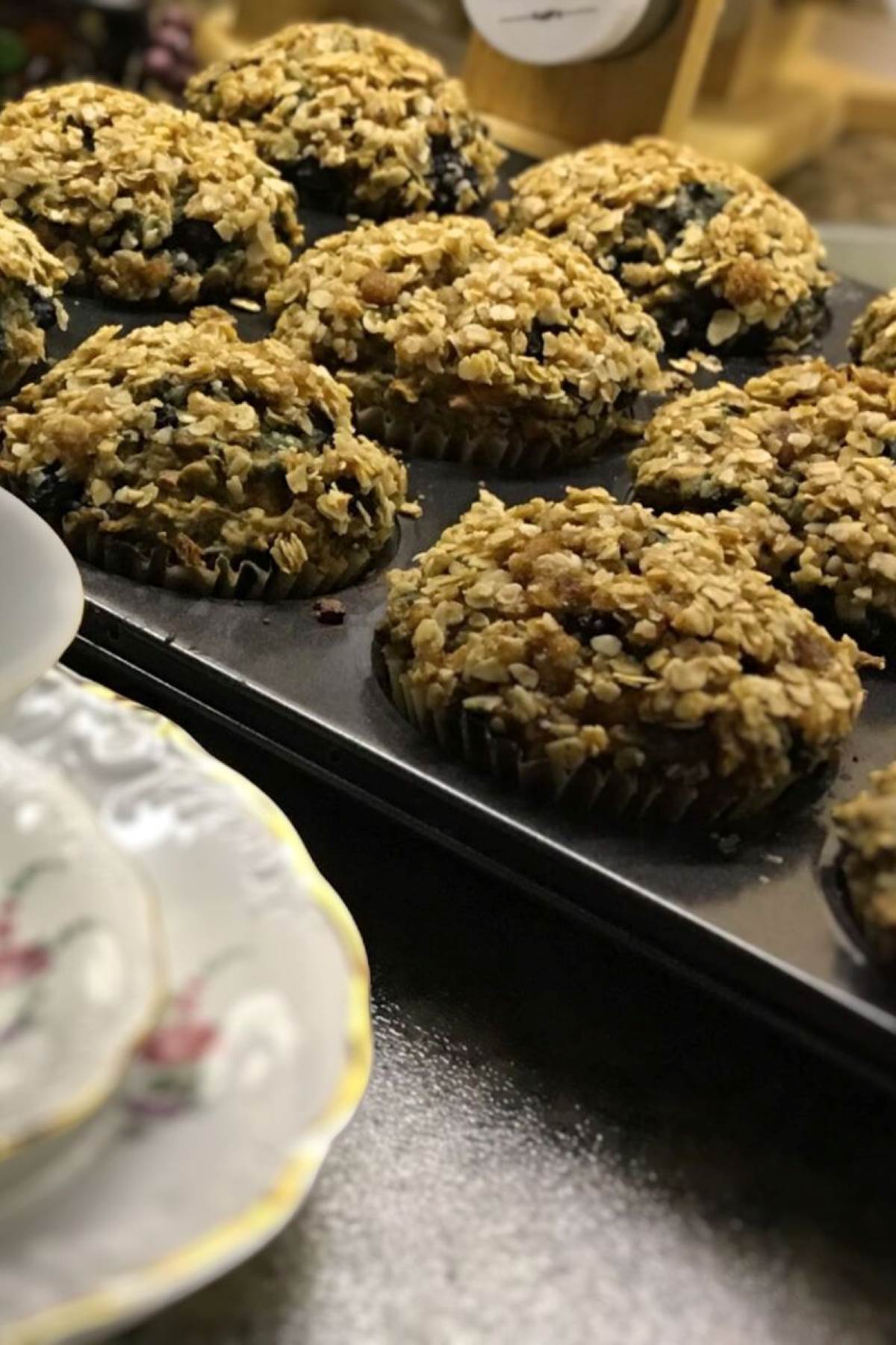 banana blueberry crumble muffins in a muffin tray.