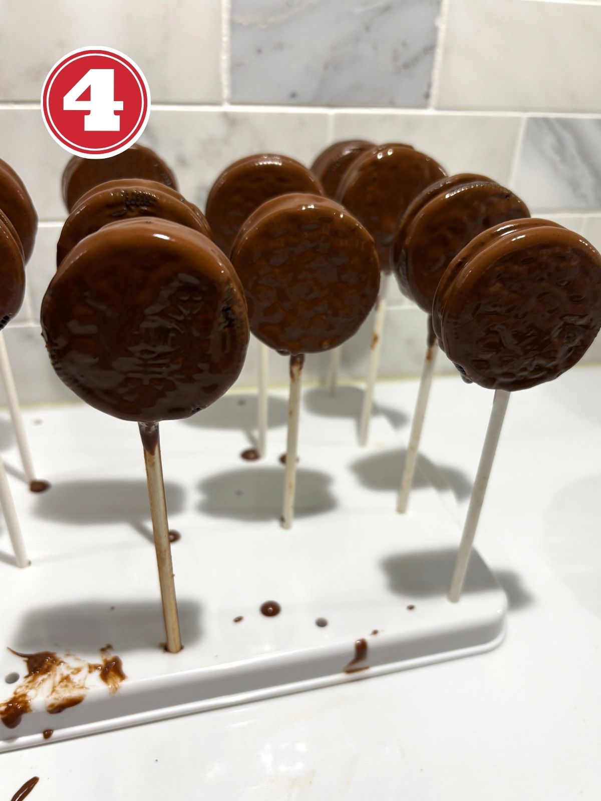 cooke pops drying on a cookie holder tray