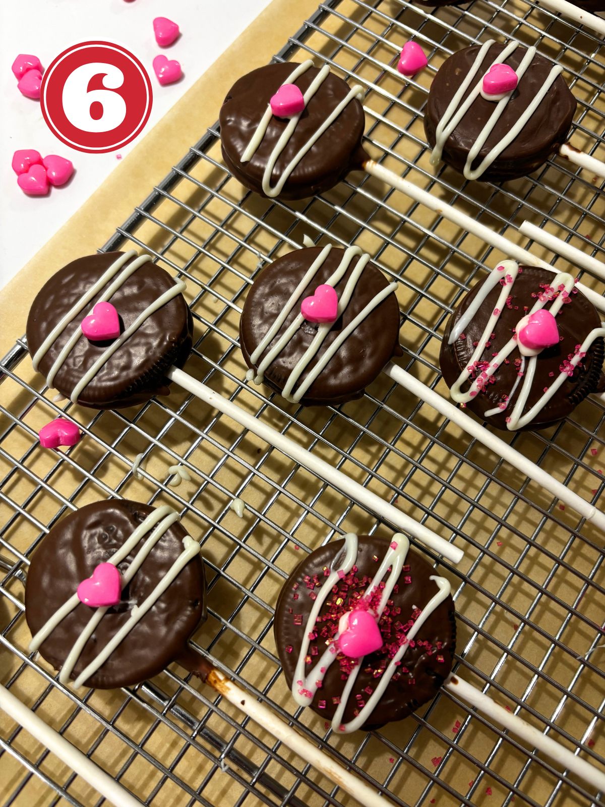 decorated cookie pops on a wire rack
