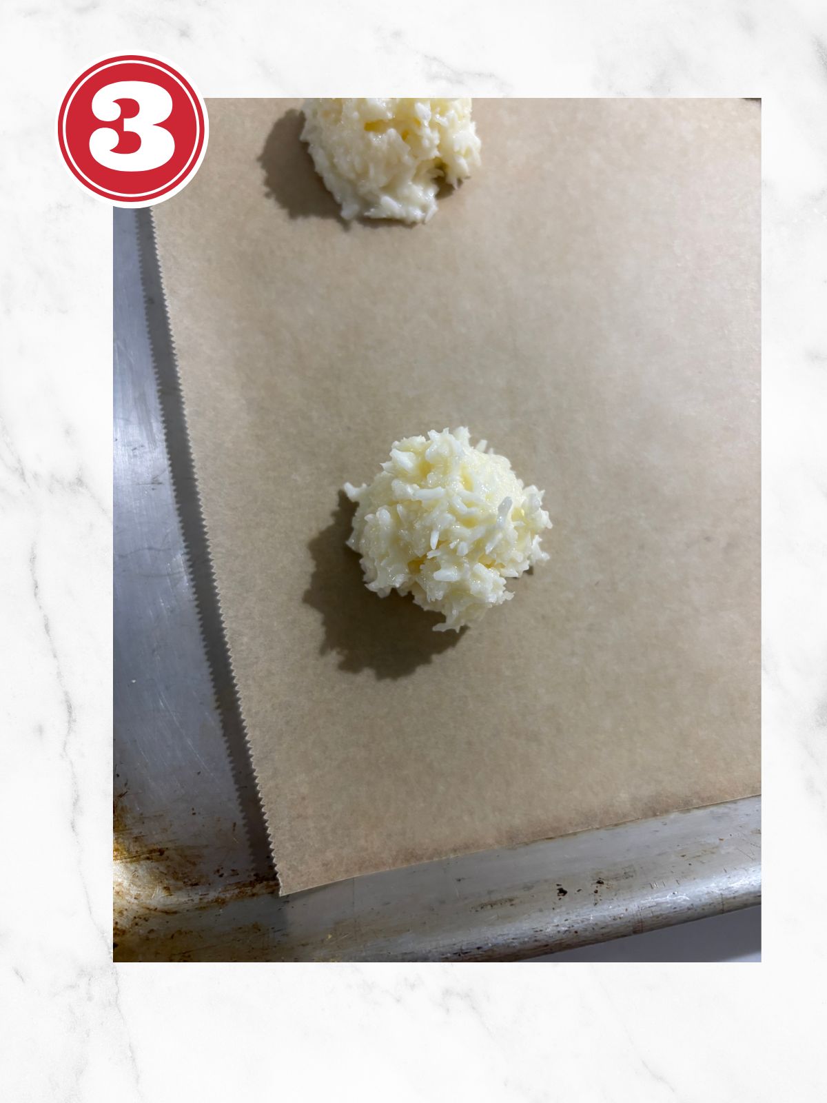 coconut macaroon on a lined baking sheet