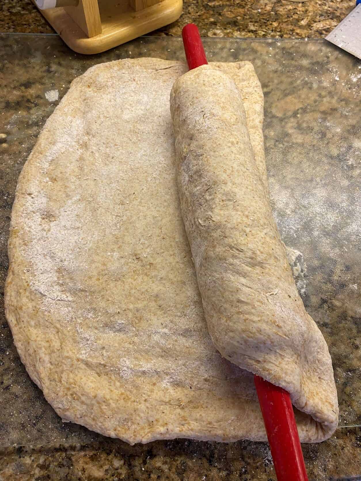 Pizza Dough on a rolling pin