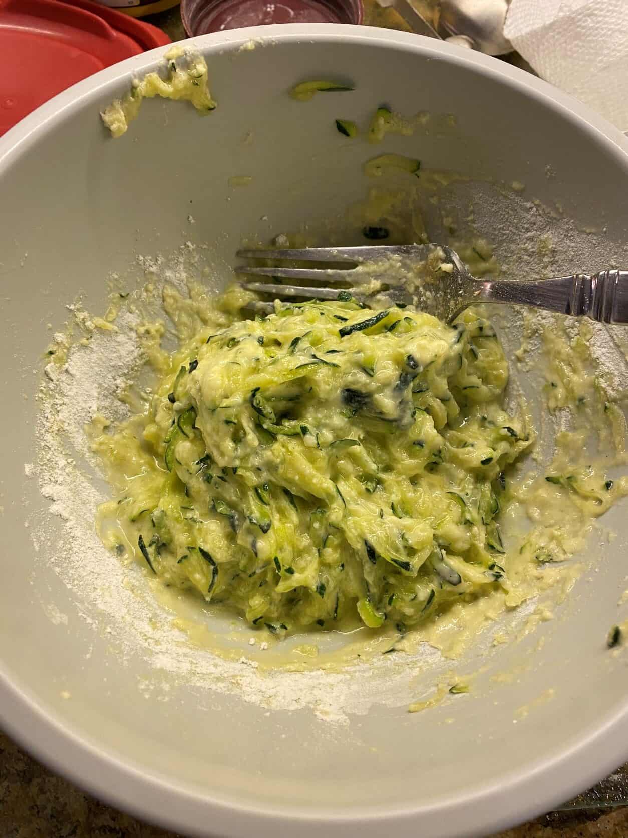 zucchini fritter batter in a bowl
