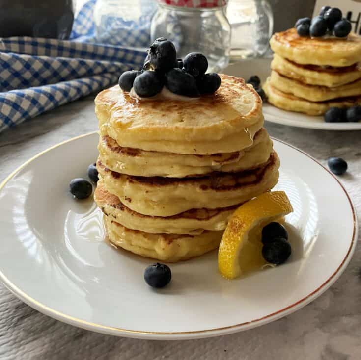 Lemon Ricotta Pancakes in a white plate with blueberries