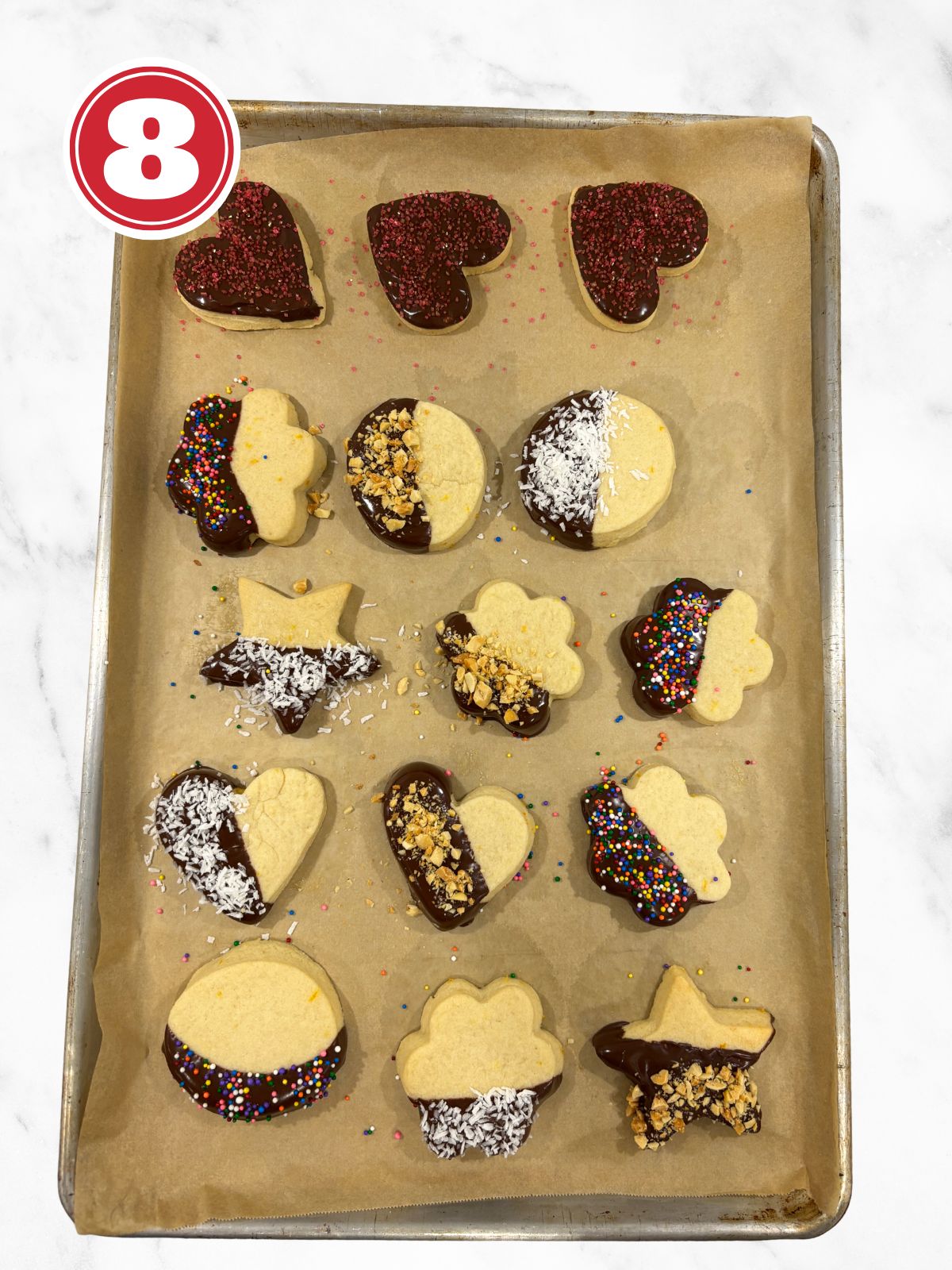 drying dipped butter cookies on a baking sheet lined with parchment paper