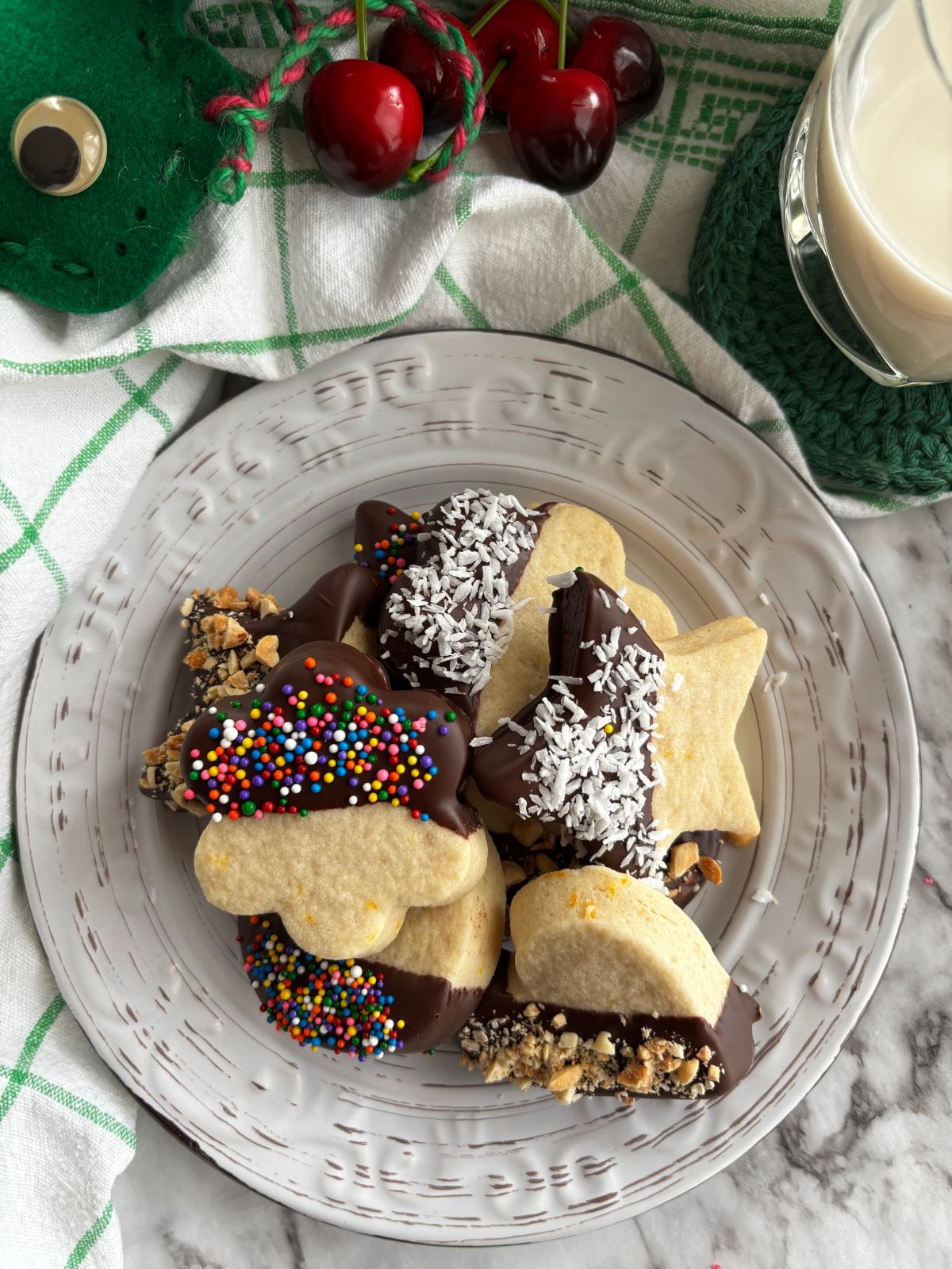 Italian butter cookies dipped in chocolate on a white plate