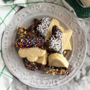 Italian butter cookies dipped in chocolate on a white plate