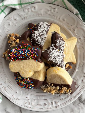 Italian butter cookies dipped in chocolate on a white plate