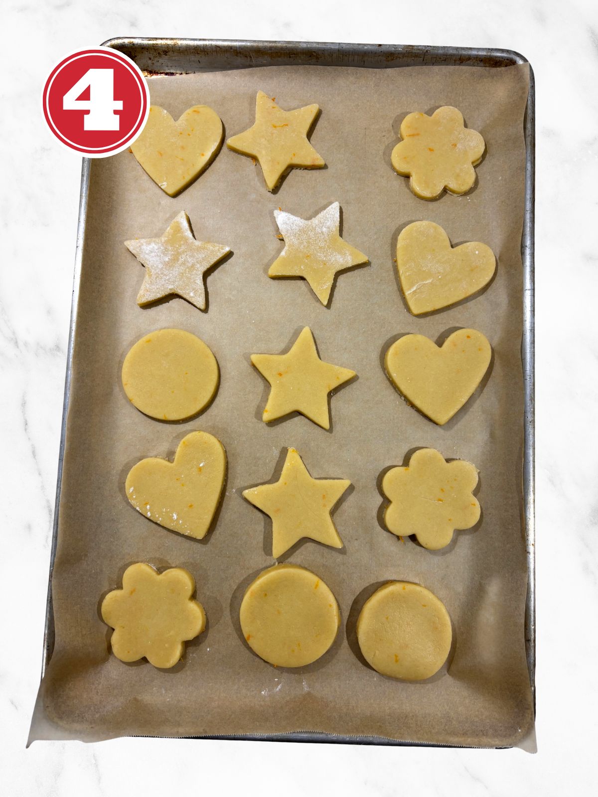 raw cookies on a baking tray lined with parchment paper