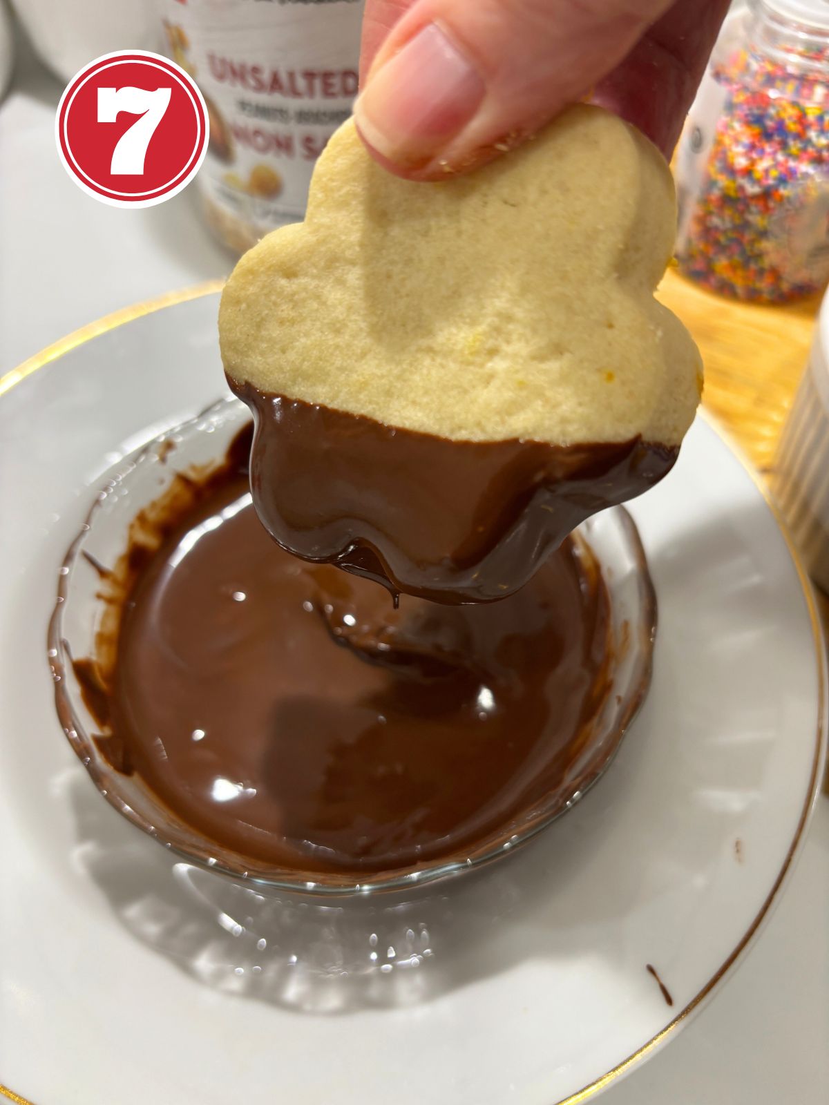 dipping baked butter cookies in melted chocolate