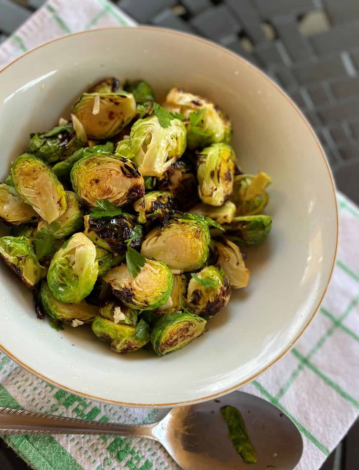 brussel sprouts in a white bowl on patio table
