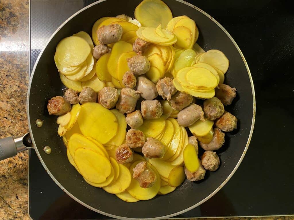 sliced potatoes and sausage in a frypan