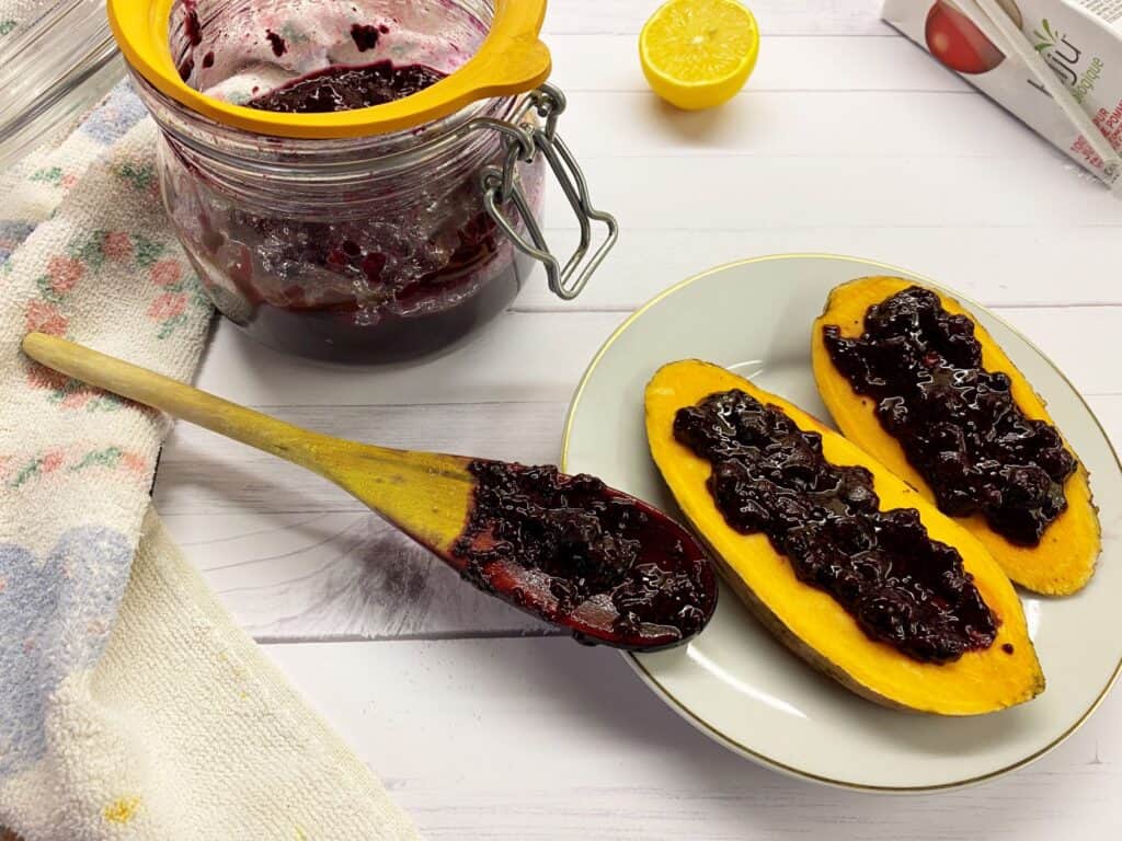 blueberry jam in a jar and on sweet potato toast