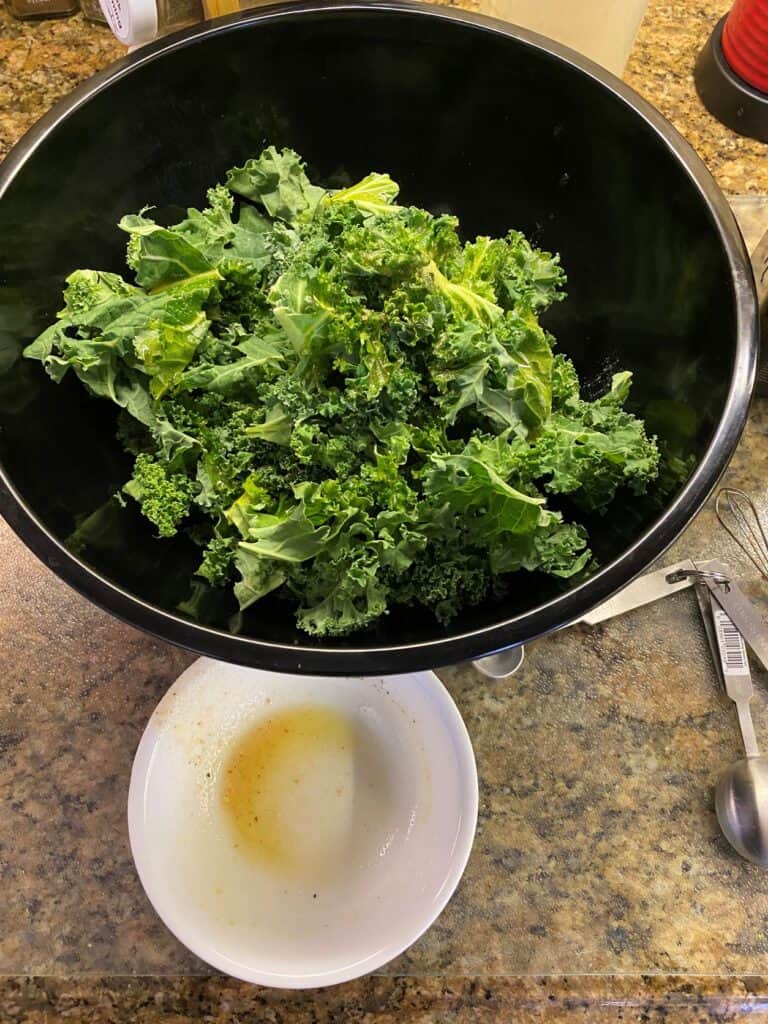 Prepping Kale Chips in a bowl