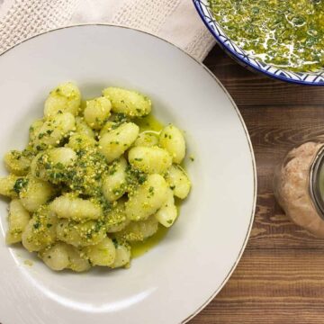 gnocchi with dairy free pesto sauce in a white bowl
