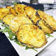 cooked breaded eggplant in a white dish