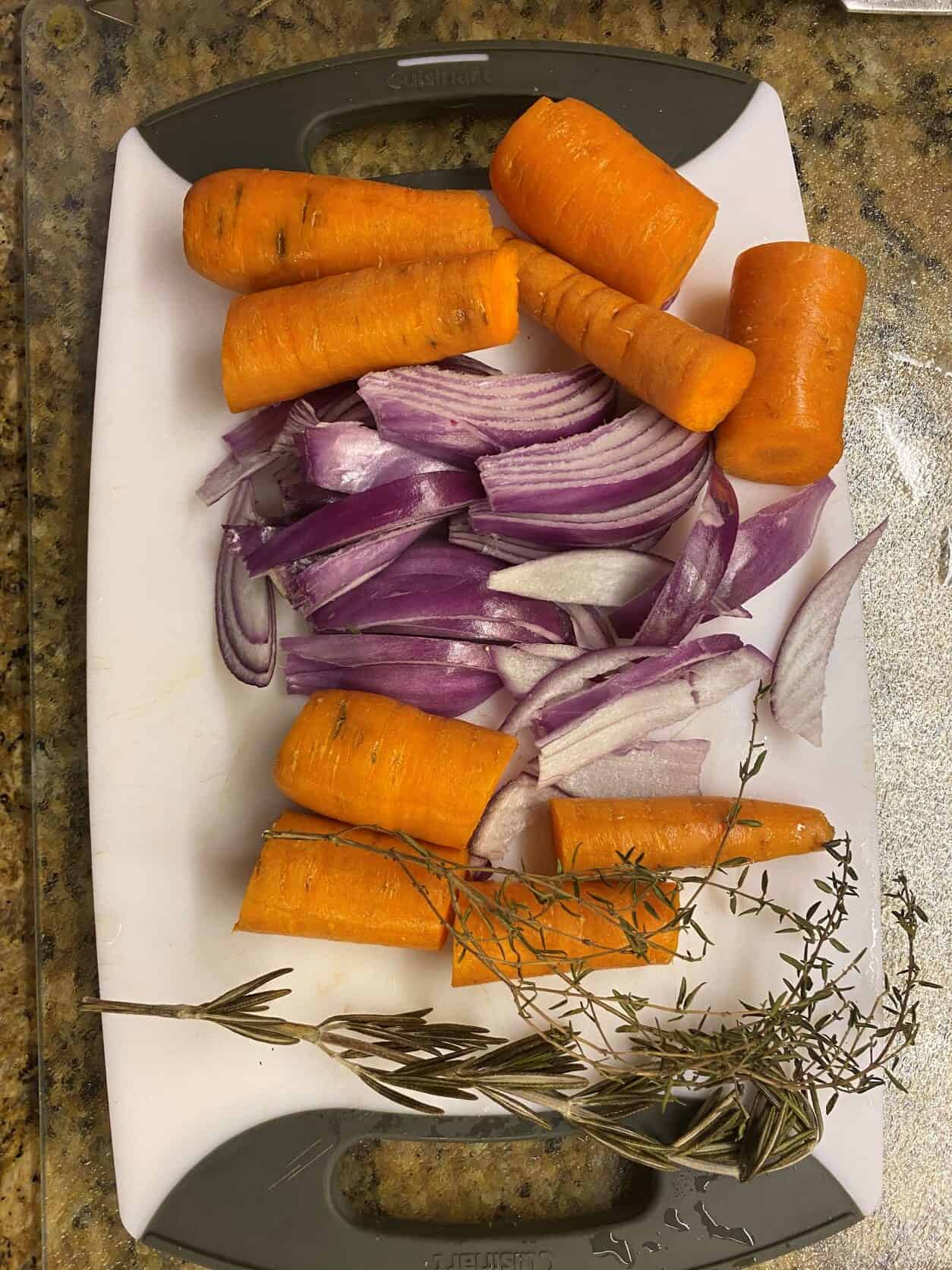 slice onions and carrots on a cutting board