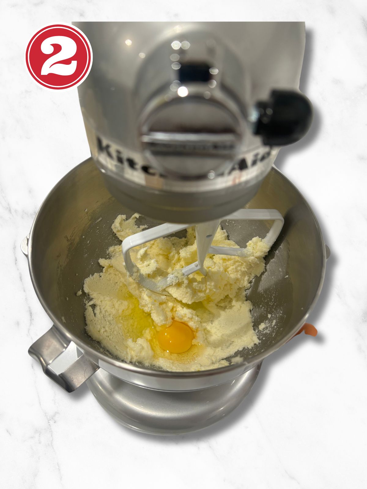 Butter and Sugar in a stand mixer adding egg