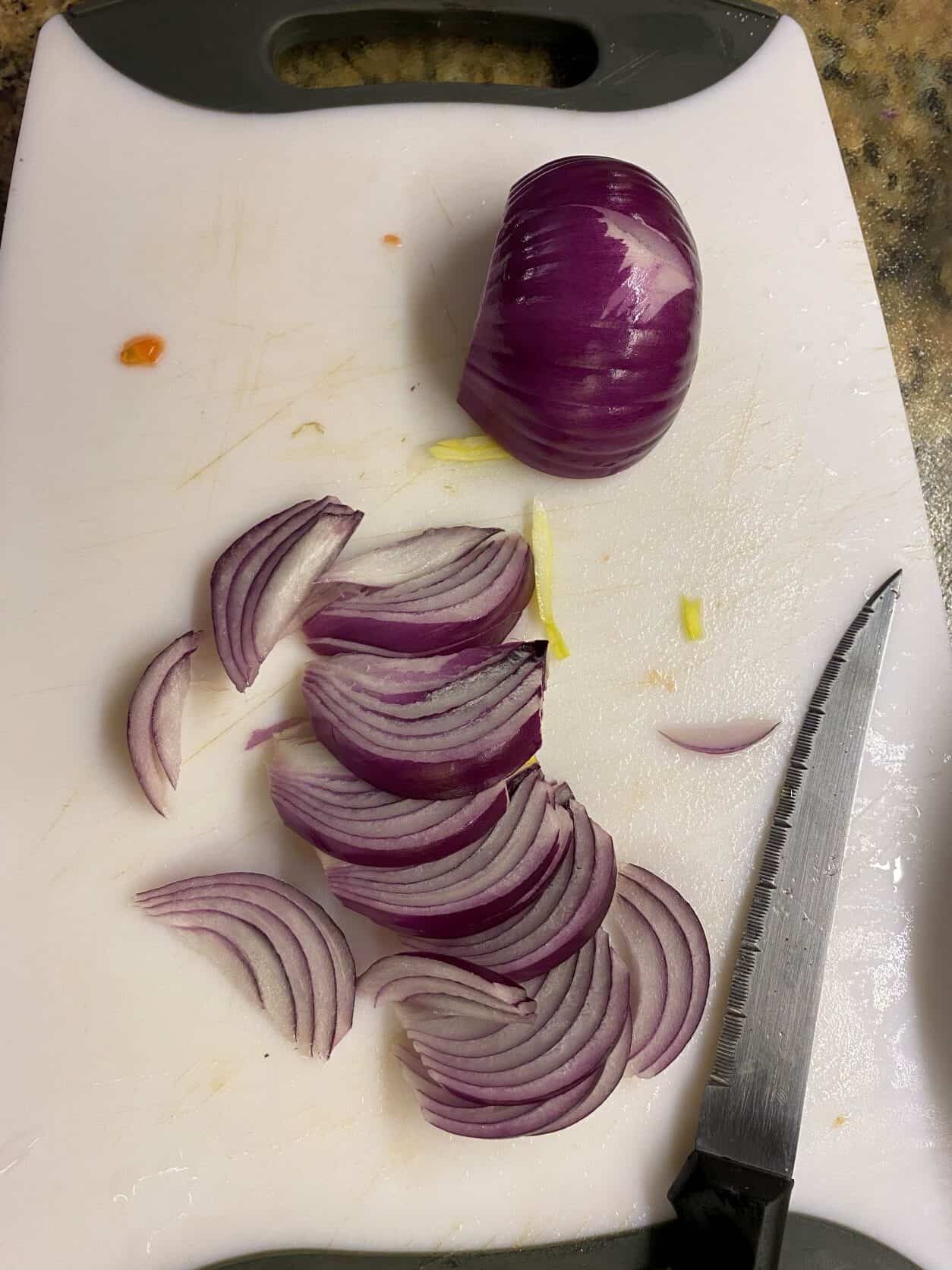 sliced red onion on a cutting board