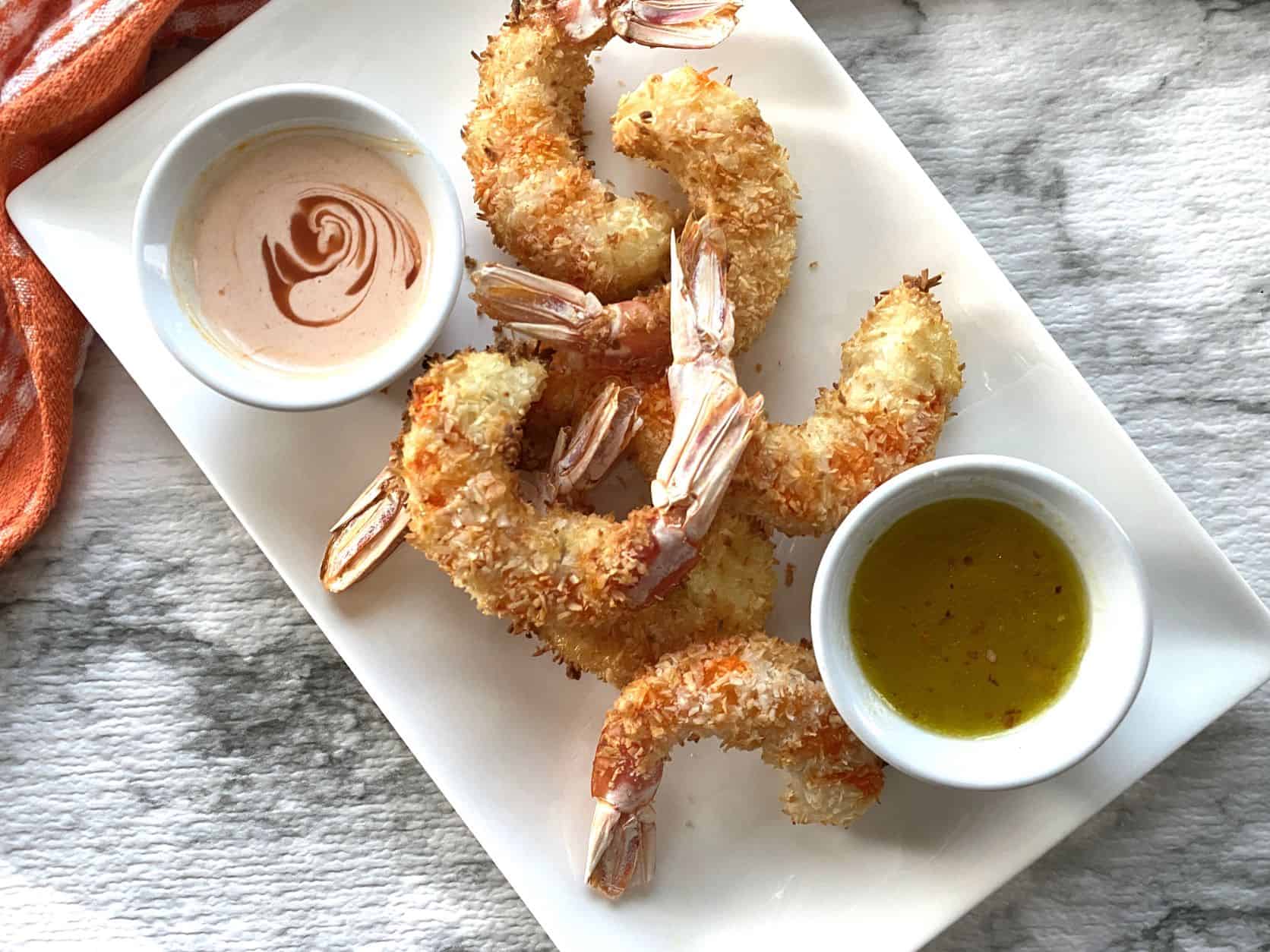 Coconut shrimp with Dipping Sauce in a white plate