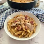 Penne all vodka with chicken in a white bowl