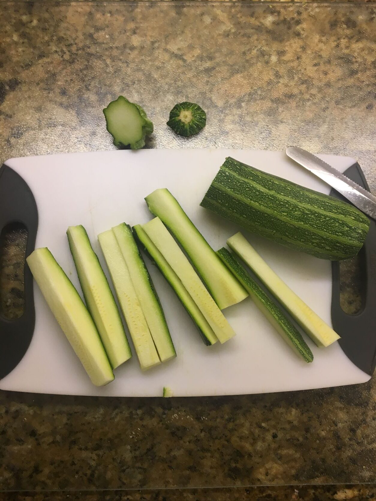 cut zucchini on a white cutting board