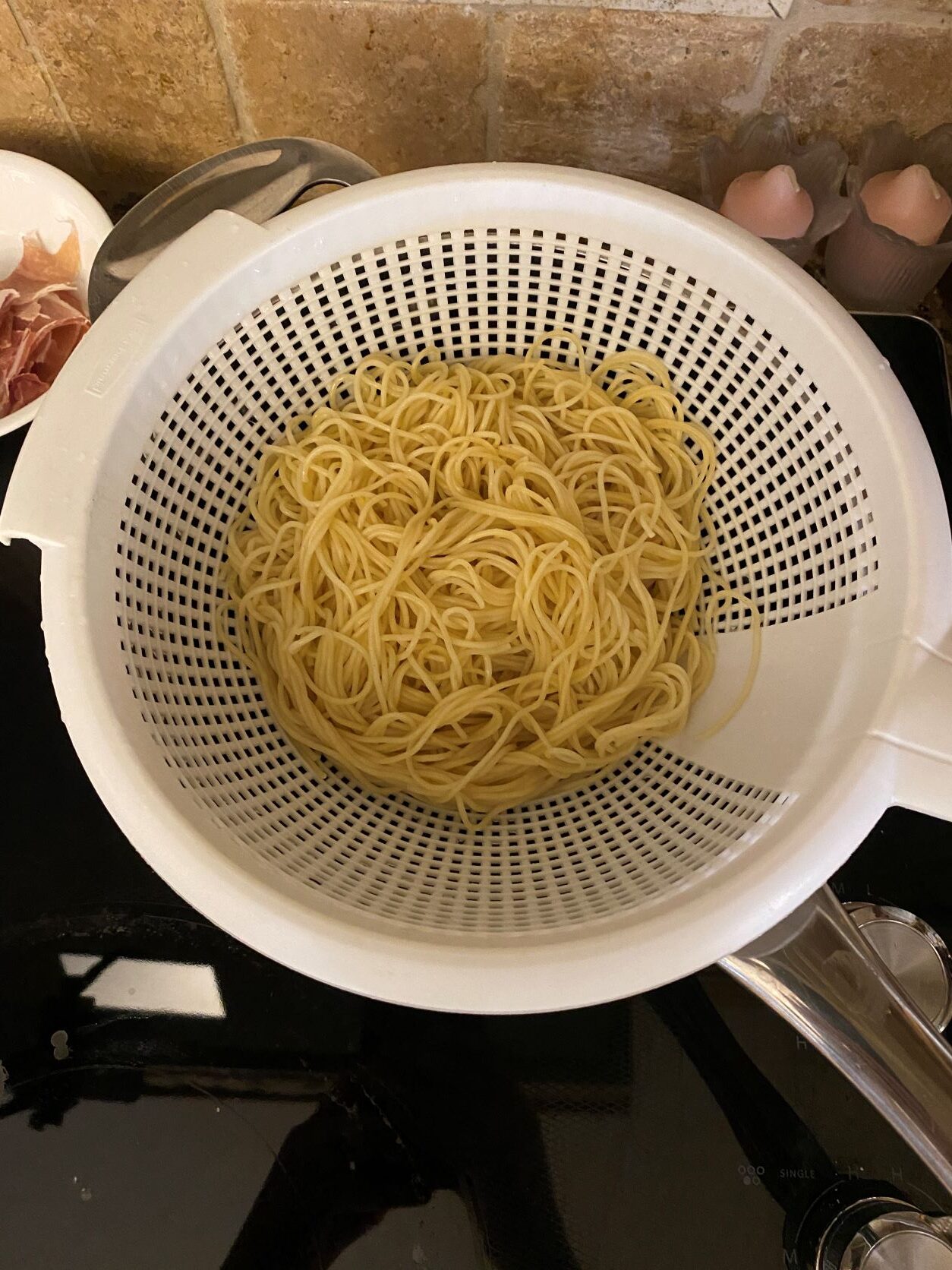 cooked leftover spaghetti in a colander