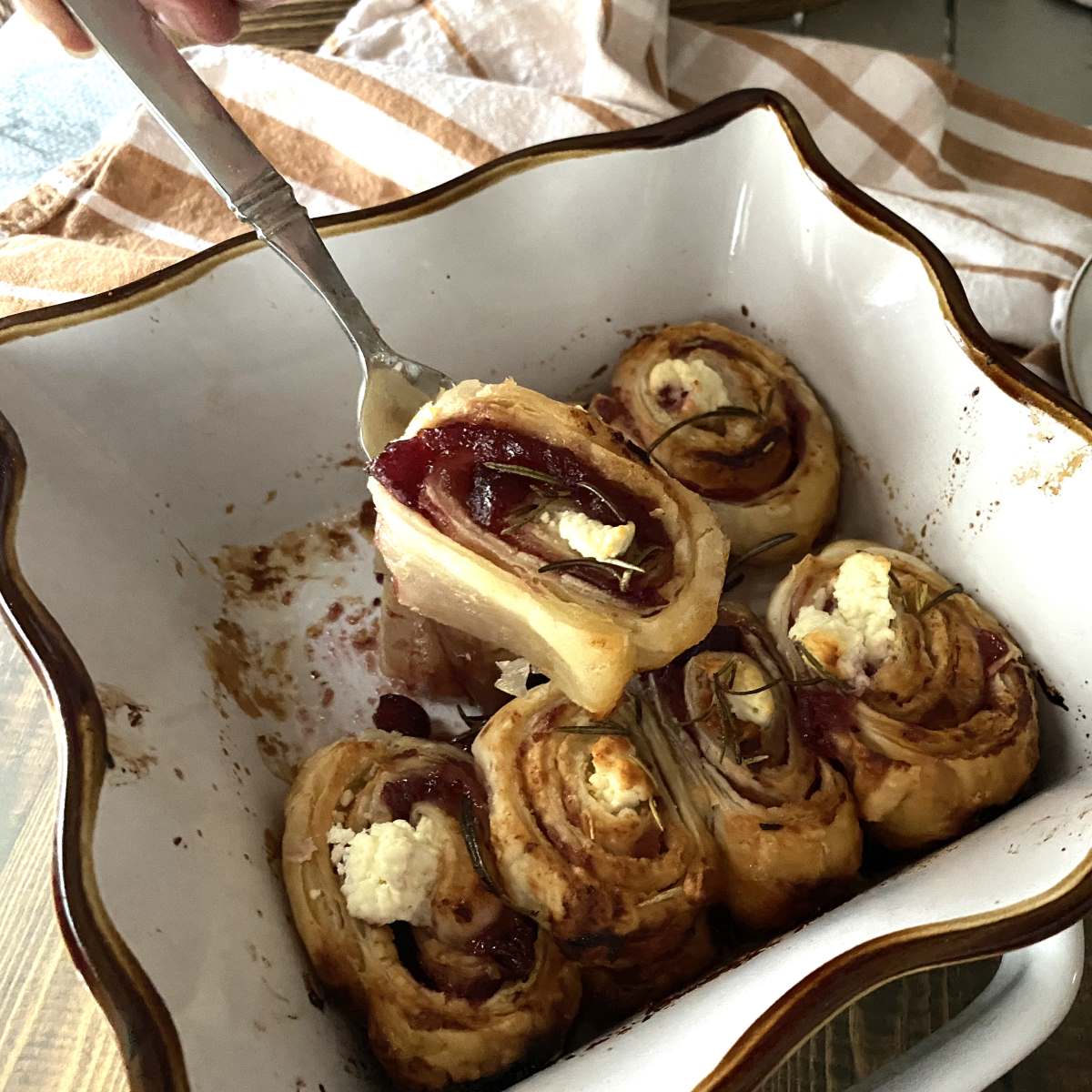 Cranberry and Goat cheese Puff Pasty rolls in a white dish