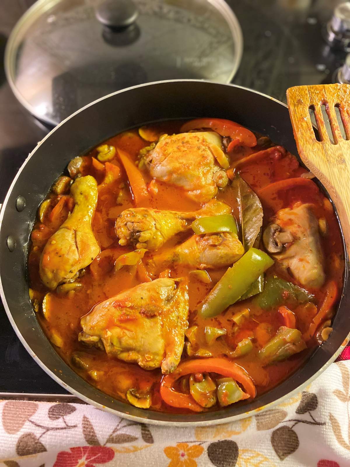 Chicken legs thighs with peppers mushrooms and sauce in a skillet cooked