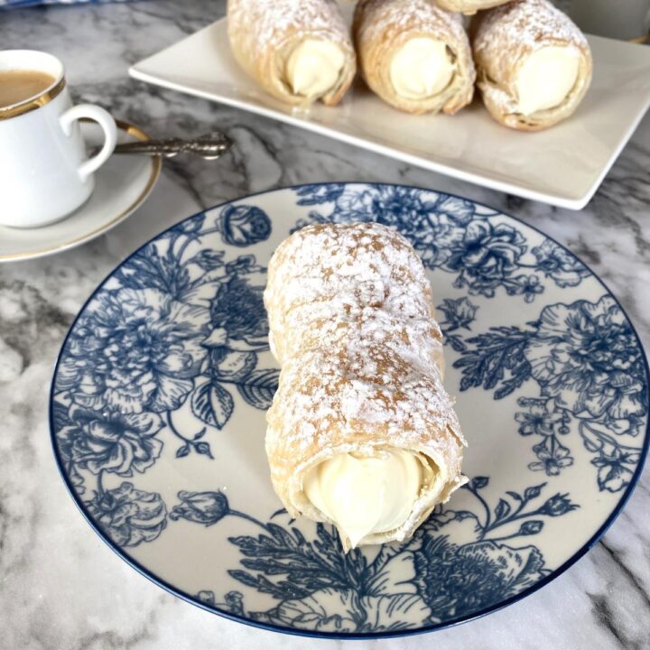puff pastry cream horn in a blue and white saucer