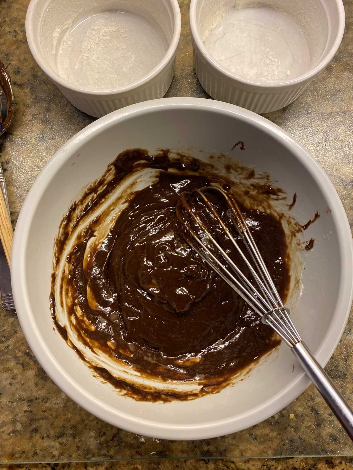 Nutella and butter in a bowl with whisk