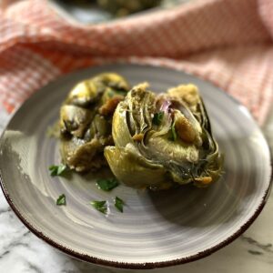 stuffed artichokes on a grey plate.
