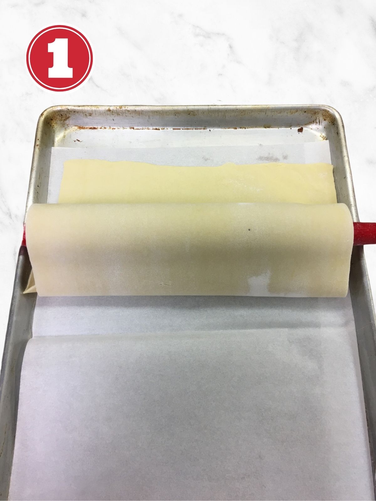 transferring puff pastry on a baking sheet