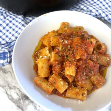 Veal Ragu sauce on pasta in a white bowl