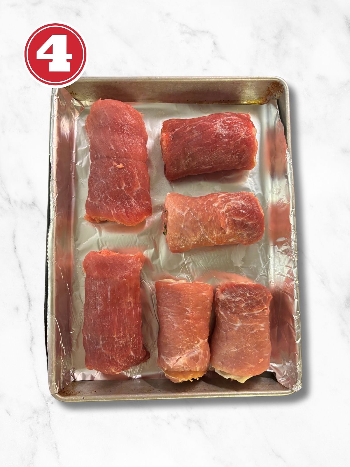 Pork Braciole on a baking sheet