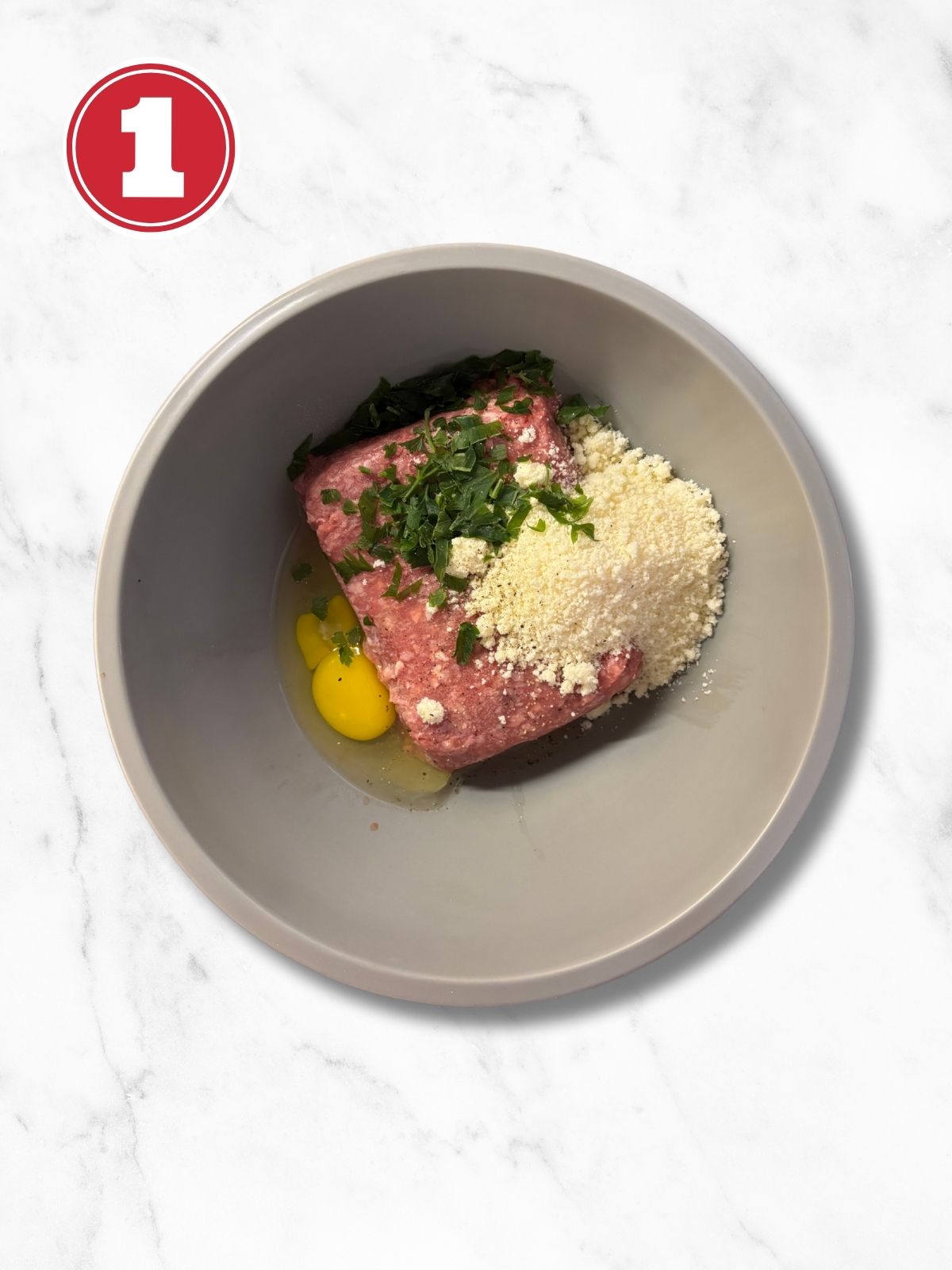 ingredients for pork braciole in a grey bowl