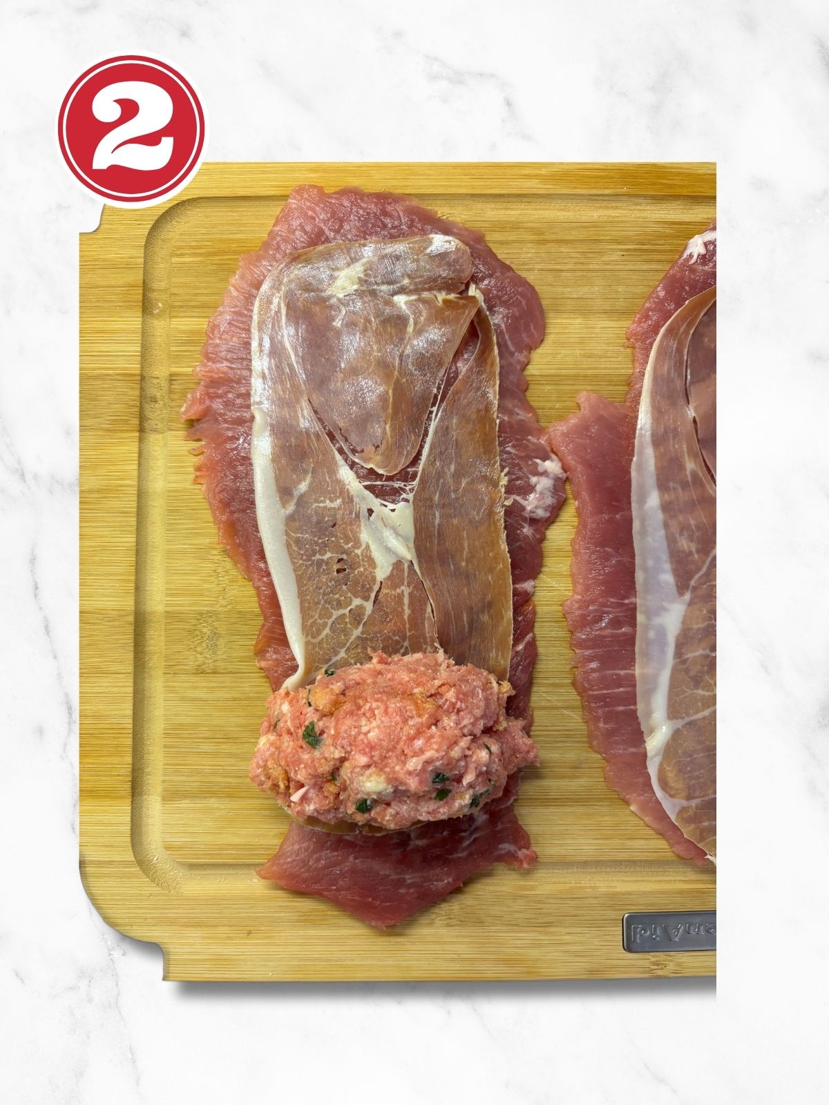 pork fillet with braciole stuffing before rolling on wooden cutting board