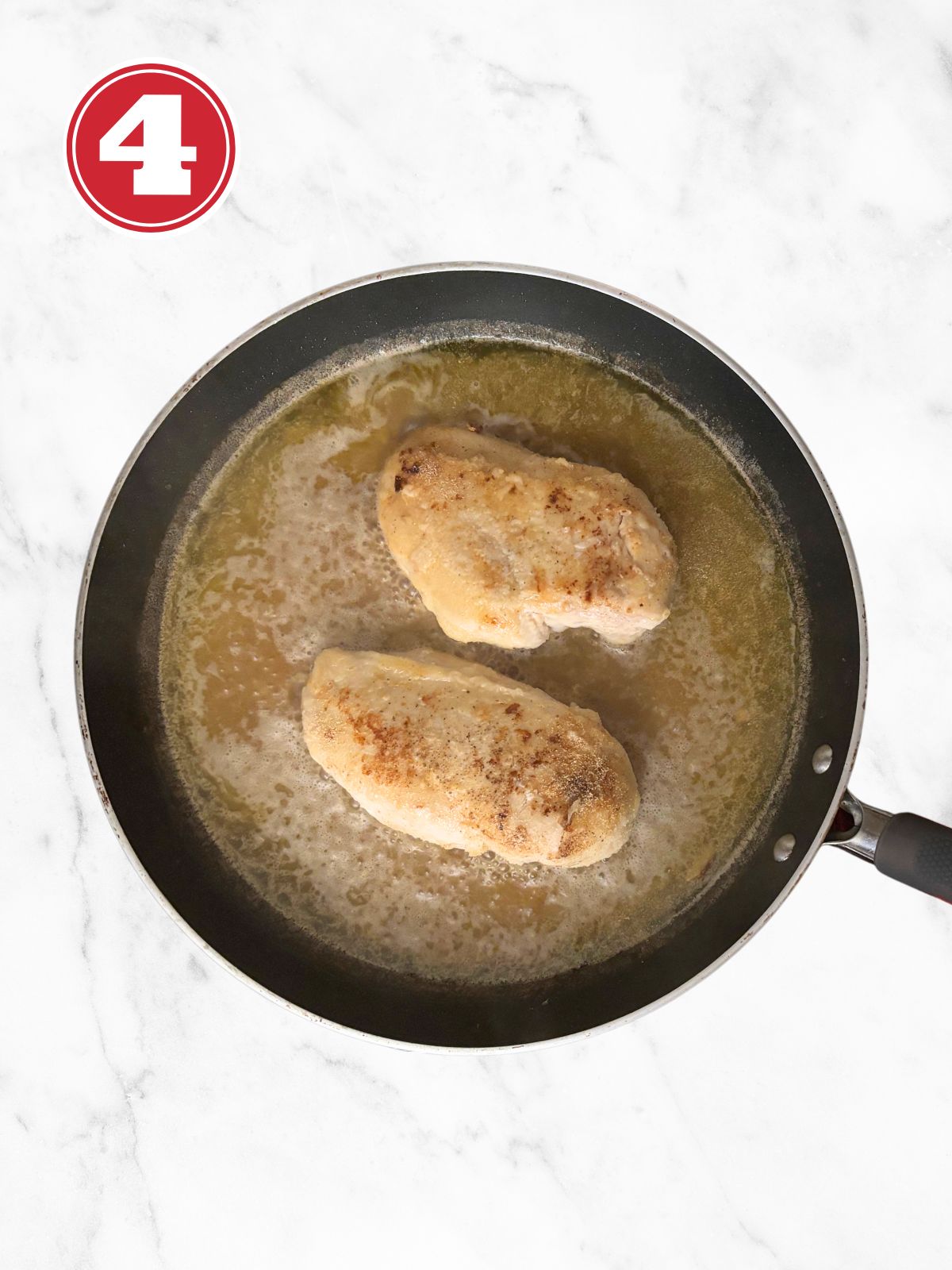 garlic chicken and broth ingredients in a skillet