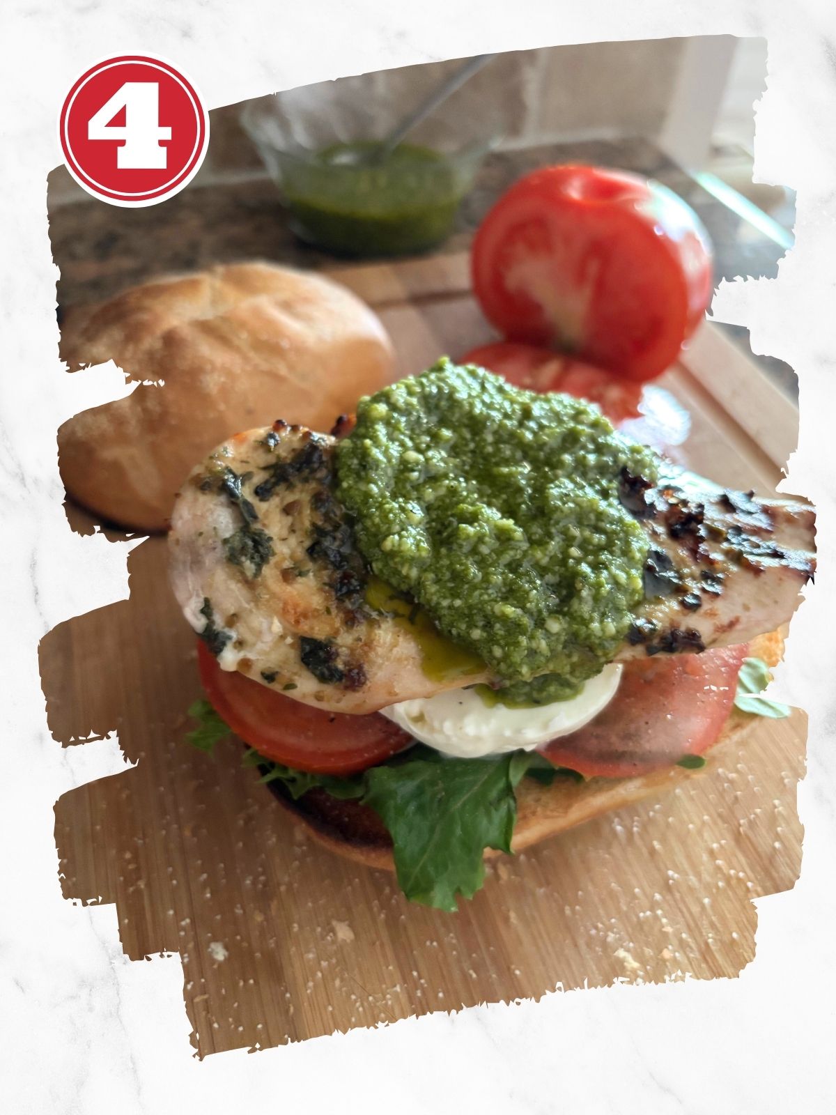 open faced caprese chicken sandwich on a wooden cutting board