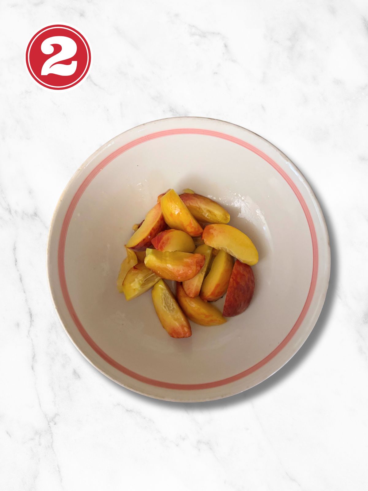 peaches, honey and lemon juice in a white bowl