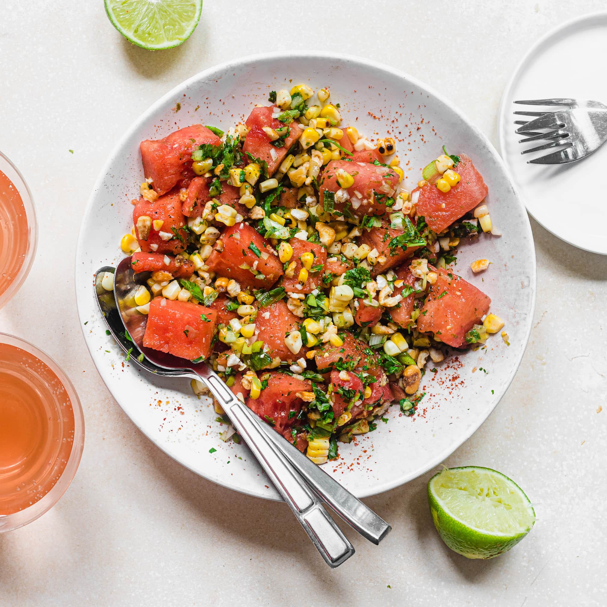 spicy watermelon salad in a white speckled bowl