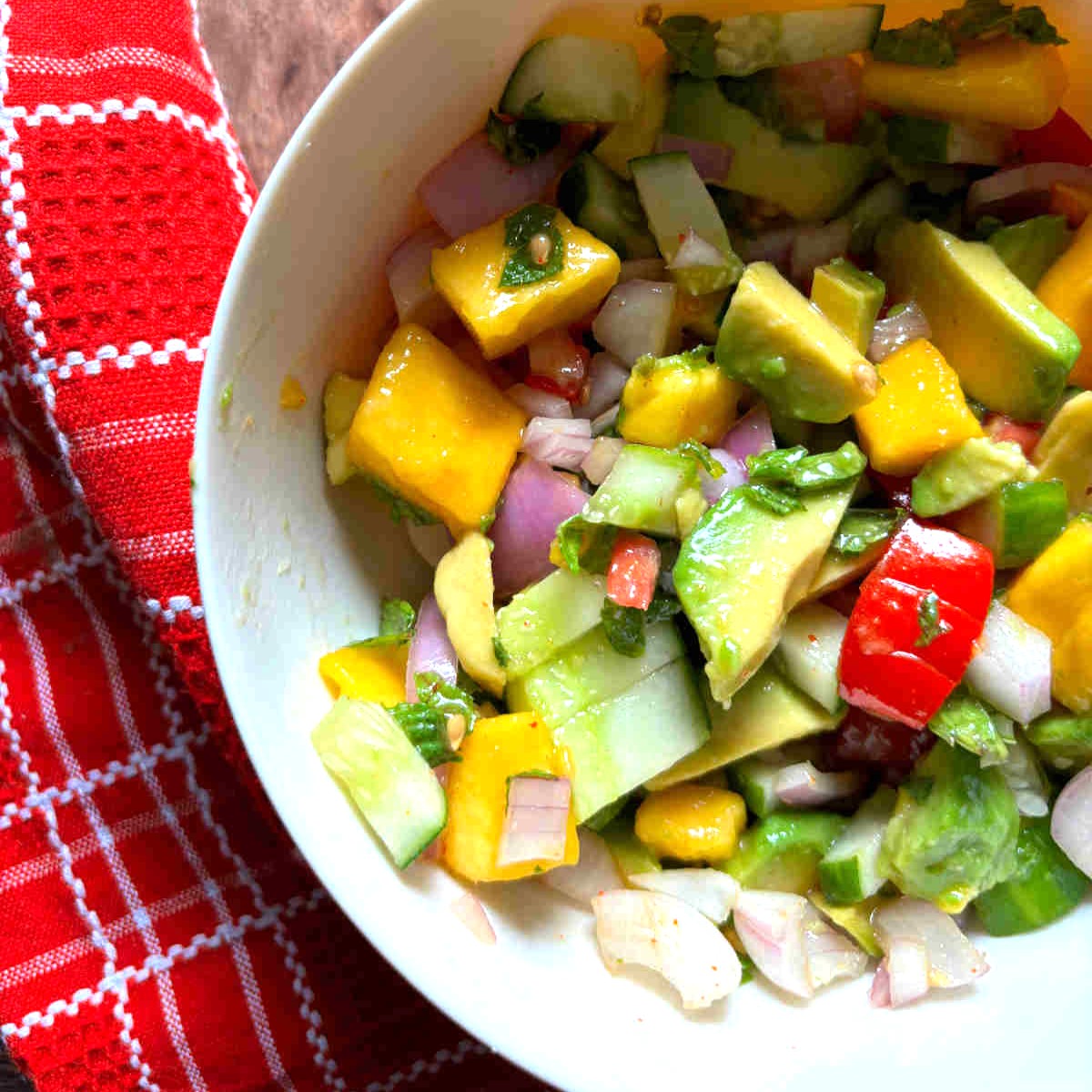 mango avocado salad in a white bowl