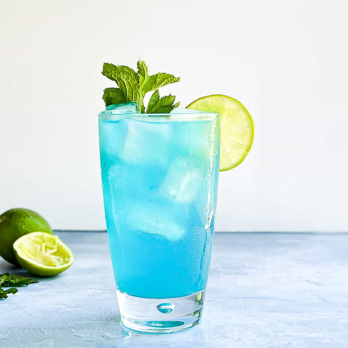 blue mojito in a tall clear glass