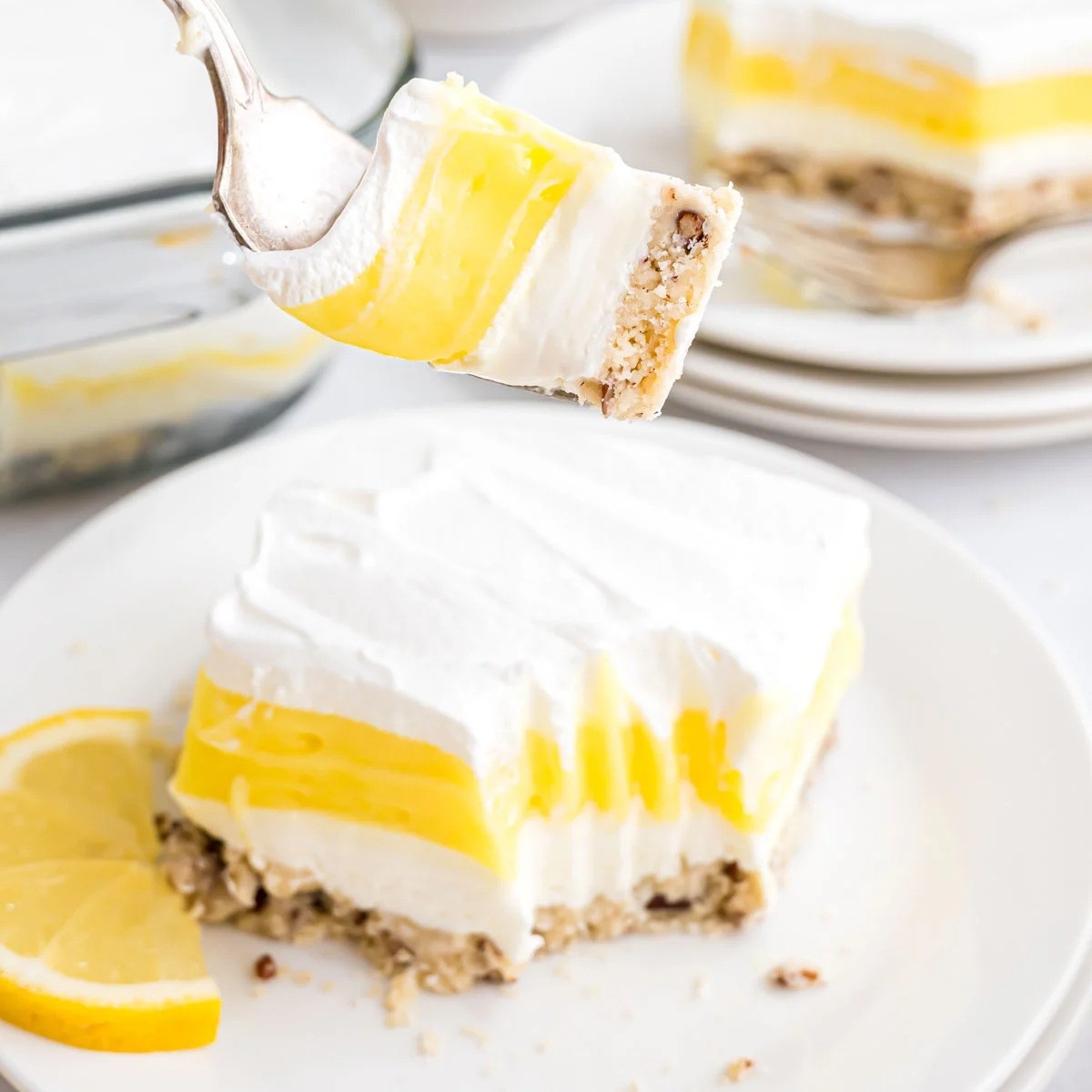 piece of lemon lush cake in a white plate