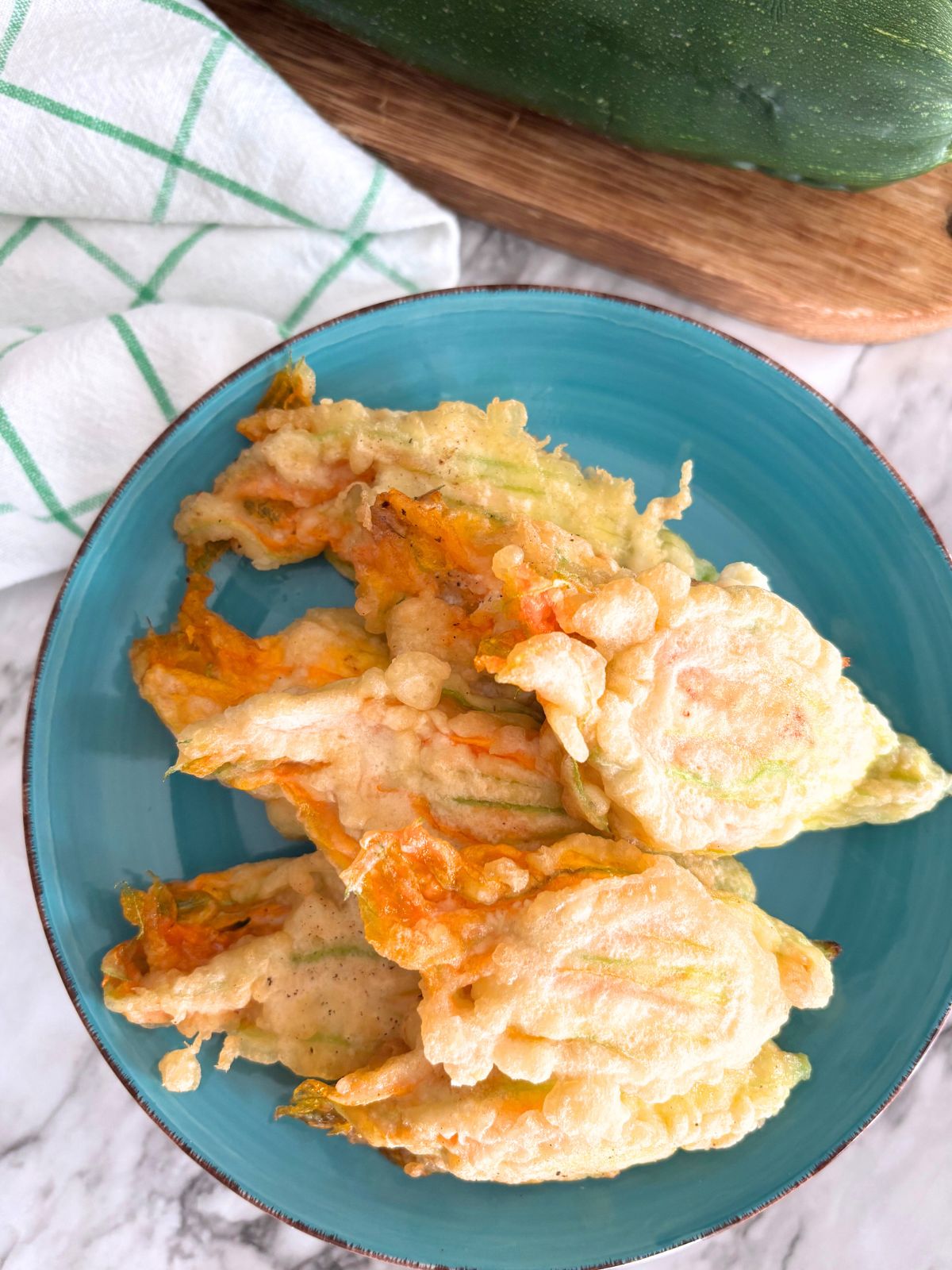 stuffed zucchini flowers in a blue plate