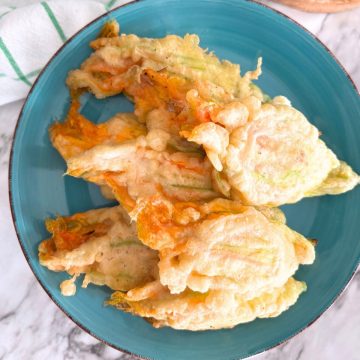 stuffed zucchini flowers in a blue plate