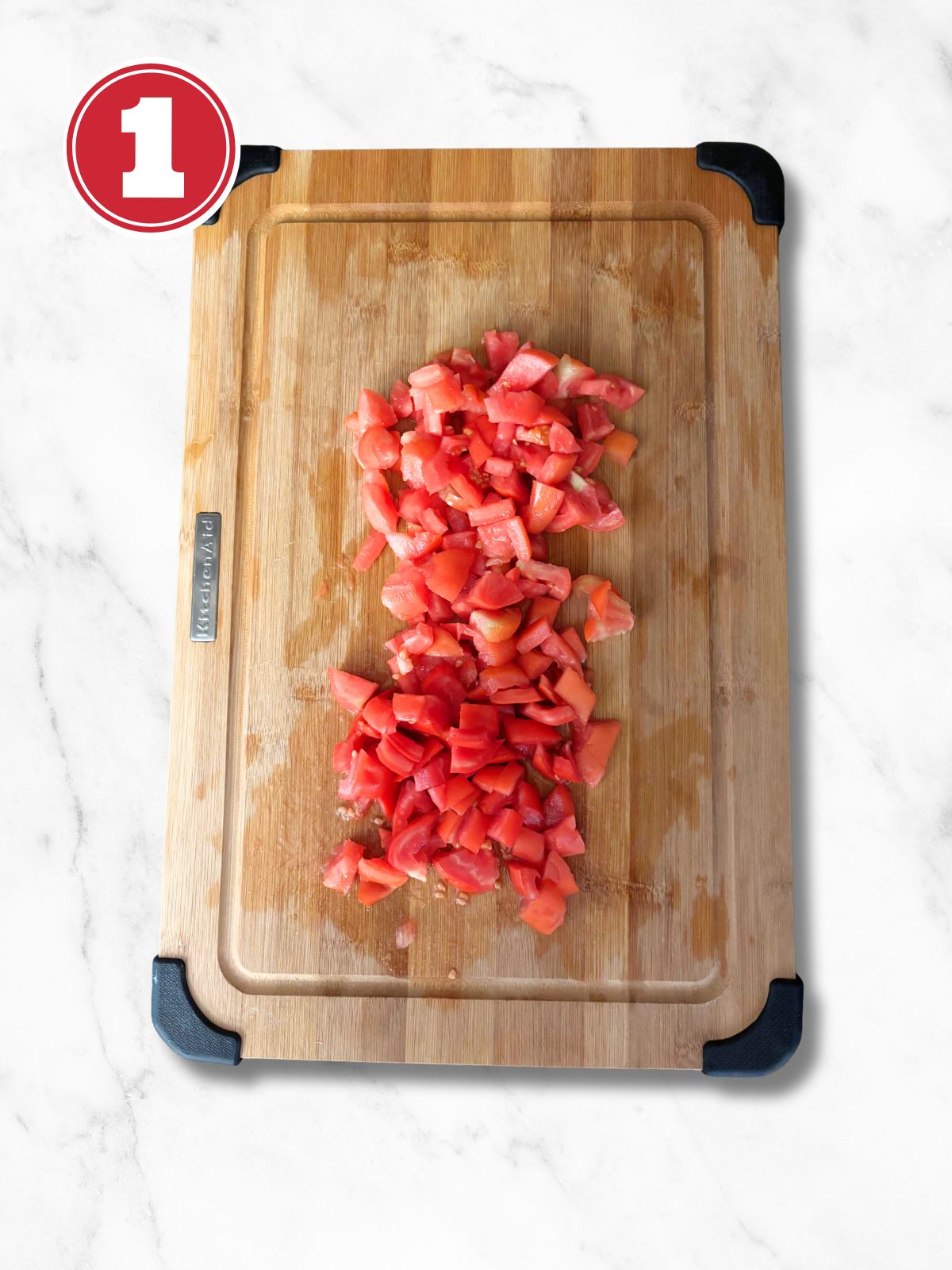 chopped tomato on a wooden cutting board