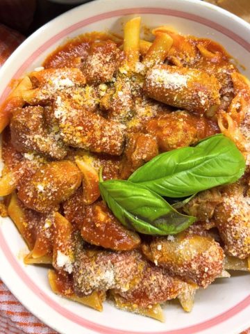 Penne Pasta with Sunday Sauce in a white bowl