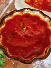 Cooked pizza sauce in a small bowl